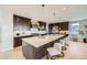 Spacious kitchen with a large island, stainless steel appliances, and elegant dark wood cabinetry at 5926 Hickory Oaks Trl, Castle Rock, CO 80104