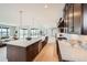 Open-concept kitchen with hardwood floors, stainless steel appliances, and an oversized central island at 5926 Hickory Oaks Trl, Castle Rock, CO 80104
