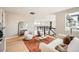 Bright open-concept living room with modern decor, light wood floors, and large windows at 5926 Hickory Oaks Trl, Castle Rock, CO 80104