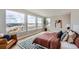 Bright primary bedroom featuring hardwood floors, large windows, and a stylish accent rug at 5926 Hickory Oaks Trl, Castle Rock, CO 80104