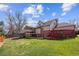 Expansive backyard showcases a well-kept lawn, wooden deck, and multi-level outdoor living spaces at 10622 Van Gordon Way, Broomfield, CO 80021