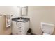 Compact bathroom featuring a granite countertop, vanity, and toilet at 10622 Van Gordon Way, Broomfield, CO 80021