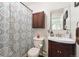 The bathroom features a shower with curtain, vanity, and a corner sink for convenience at 10622 Van Gordon Way, Broomfield, CO 80021