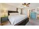 Comfortable bedroom with modern ceiling fan, and view to the on-suite bathroom at 10622 Van Gordon Way, Broomfield, CO 80021