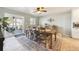 Bright dining room with a large wooden table, sliding doors to the patio, and neutral decor at 10622 Van Gordon Way, Broomfield, CO 80021