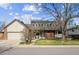 Charming two-story home featuring a well-manicured lawn, brick accents and solar panels on the roof at 10622 Van Gordon Way, Broomfield, CO 80021
