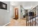 Bright foyer features tile flooring, decorative wood door, and staircase leading to the living area at 10622 Van Gordon Way, Broomfield, CO 80021