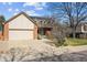 Charming home with a two-car garage, brick facade, and well-manicured front yard creates curb appeal at 10622 Van Gordon Way, Broomfield, CO 80021