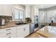 Bright kitchen featuring granite counters, stainless steel appliances, mosaic backsplash, and white cabinets at 10622 Van Gordon Way, Broomfield, CO 80021
