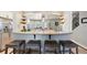 Spacious gourmet kitchen with white cabinets, stone countertops, stainless steel appliances, and bar stool seating at 10622 Van Gordon Way, Broomfield, CO 80021