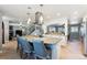 Open concept view from kitchen island into living room, dining room, and stairway to second floor at 10622 Van Gordon Way, Broomfield, CO 80021