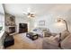 Inviting living room featuring a stone fireplace, plush carpeting, and comfortable seating arrangements at 10622 Van Gordon Way, Broomfield, CO 80021
