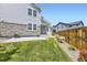 Backyard featuring a well-maintained lawn, stone accents, and wooden privacy fence at 9111 W 100Th Way, Broomfield, CO 80021