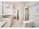 Well-lit bathroom featuring double vanity, tiled floor and glass enclosed shower and walk in closet at 9111 W 100Th Way, Broomfield, CO 80021