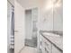 Bathroom showcasing granite countertop vanity, shower, and access to another living area at 9111 W 100Th Way, Broomfield, CO 80021