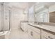 Well-lit bathroom featuring double vanity, tiled floor and glass enclosed shower at 9111 W 100Th Way, Broomfield, CO 80021