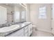 Bright bathroom featuring a double sink vanity with granite countertop and tile floors at 9111 W 100Th Way, Broomfield, CO 80021