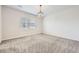 Light-filled bedroom with neutral carpet and a modern chandelier at 9111 W 100Th Way, Broomfield, CO 80021