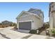 Two-car garage with gray door and neutral-colored siding, located in a residential neighborhood at 9111 W 100Th Way, Broomfield, CO 80021