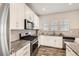 Bright kitchen with stainless steel appliances, granite countertops, and sleek white cabinetry at 9111 W 100Th Way, Broomfield, CO 80021