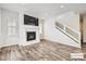 Modern living room features a fireplace, a staircase, and beautiful hardwood floors at 9111 W 100Th Way, Westminster, CO 80021