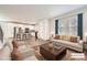 Bright living room with modern decor, hardwood floors, and seamless flow to the open kitchen at 9111 W 100Th Way, Westminster, CO 80021