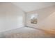 A cozy bedroom featuring carpet floors, a window, and neutral walls at 18508 E Whitaker Cir # D, Aurora, CO 80015