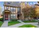 Charming townhome featuring a stone facade and mature landscaping at 18508 E Whitaker Cir # D, Aurora, CO 80015