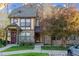 Charming townhome featuring a stone facade and mature landscaping at 18508 E Whitaker Cir # D, Aurora, CO 80015
