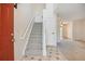 Bright foyer with a staircase, tiled entryway, and neutral decor at 18508 E Whitaker Cir # D, Aurora, CO 80015