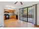 Eat-in kitchen featuring wood cabinets, stainless steel appliances, and sliding glass door to patio at 18508 E Whitaker Cir # D, Aurora, CO 80015