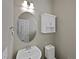 Charming powder room with a vanity, decorative mirror and cabinet for storage at 8632 Yule St, Arvada, CO 80007