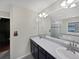 Bathroom featuring double sinks, a large mirror, and a view of the bathtub and shower at 8632 Yule St, Arvada, CO 80007