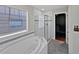 Bright bathroom with a soaking tub, glass-enclosed shower, and a walk-in closet at 8632 Yule St, Arvada, CO 80007