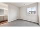 A clean bedroom featuring neutral colors, a view, and an ensuite bathroom at 2501 Lupton Ln, Lafayette, CO 80026