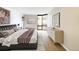 Bright bedroom featuring modern decor, hardwood floors, and large windows at 1625 Larimer St # 1001, Denver, CO 80202
