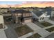 Aerial shot of a two-story home with a well-kept lawn, long driveway, and two car garage in a residential neighborhood at 18014 Tree Sparrow Ave, Parker, CO 80134
