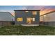 Backyard featuring a stone patio and spacious lawn, framed by a privacy fence, perfect for entertainment or quiet enjoyment at 18014 Tree Sparrow Ave, Parker, CO 80134