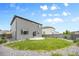 Fenced backyard with a well-maintained lawn, concrete patio, and low maintenance gravel landscaping at 18014 Tree Sparrow Ave, Parker, CO 80134