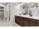 Bathroom features a double vanity, quartz countertops, and tile flooring at 18014 Tree Sparrow Ave, Parker, CO 80134