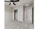 Bedroom with neutral carpet, ceiling fan, and closet with sliding doors at 18014 Tree Sparrow Ave, Parker, CO 80134