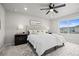 Spacious primary bedroom featuring a ceiling fan and windows with neighborhood views at 18014 Tree Sparrow Ave, Parker, CO 80134