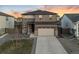 Charming two-story home with a two car garage, neutral color scheme, and stone facade accents at 18014 Tree Sparrow Ave, Parker, CO 80134