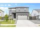 Charming two-story home with a two-car garage, stone accents, and manicured front lawn at 18014 Tree Sparrow Ave, Parker, CO 80134