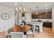 An open concept kitchen boasts stainless appliances, wood floors, granite counters, and dark cabinets at 18014 Tree Sparrow Ave, Parker, CO 80134