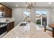 Bright kitchen with granite counters and stainless appliances faces a sliding glass door and backyard at 18014 Tree Sparrow Ave, Parker, CO 80134