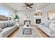 Inviting living room with a modern fireplace, plush sofas, and hardwood floors at 18014 Tree Sparrow Ave, Parker, CO 80134