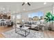 Open-concept living area with hardwood floors, a large window, and an adjacent dining area at 18014 Tree Sparrow Ave, Parker, CO 80134