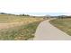 Scenic walking path through a grassy area, perfect for outdoor activities and enjoying nature at 18014 Tree Sparrow Ave, Parker, CO 80134