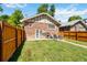 Large backyard with a patio set on a concrete slab and newly stained wooden fence at 900 Jackson St, Denver, CO 80206